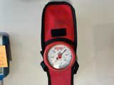 a red and black pocket watch with a black strap