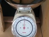 a scale with a bowl on top of it on a shelf