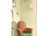 a picture of a chair and a mirror in a room