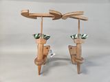 two umbrellas that are made out of wood on a stand
