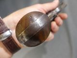 a person holding a metal object in their hand