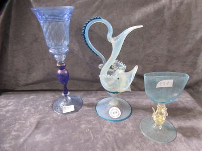 three wine glasses and a vase sitting on a table