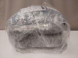 a sandwich wrapped in plastic sitting on a table