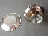 a silver plate and a silver cup on a table