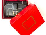 a red box with a black wallet inside of it