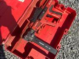 a red tool box with tools in it on the ground