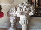 a small statue of a man with a red hat and a teddy bear