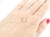 a woman ' s hand with a diamond ring on it