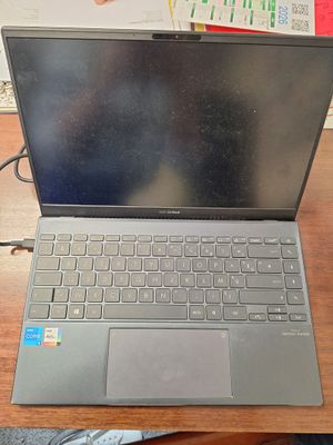 a laptop computer sitting on top of a wooden desk