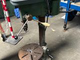 a man that is working on a machine in a garage