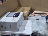 many boxes of electronic equipment in a large warehouse