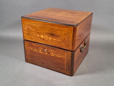 a small wooden box with two drawers on it