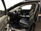 the interior of a car with the door open and the driver ' s seat up