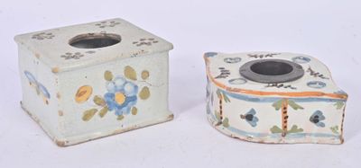 two small vases sitting next to each other on a white surface
