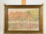 an oil painting of a lake with trees in the background and a wooden easel
