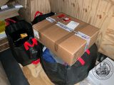 a pile of boxes sitting on top of a black bag