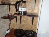 a small table with two bowls and a coffee pot on it