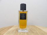 an image of a bottle of perfume sitting on a wooden table