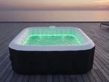 a hot tub that is lit up with green lights