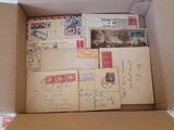 a cardboard box filled with old postcards and envelopes