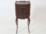 an image of a small wooden chest of drawers on a stand