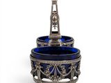 an antique silver and blue glass bowl on a stand