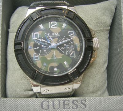 a picture of a watch in a box with a camouflage dial