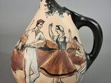 a vase with a painting on it on a table