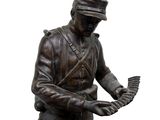 a statue of a man holding a bird on top of a boat