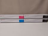 two white boxes with pink and blue labels sit on top of each other