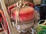 a red fire hydrant sitting on a cart in a garage