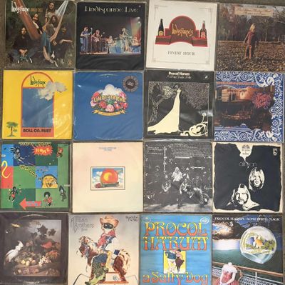 a lot of records on the wall of a room