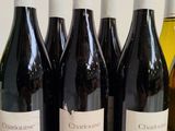 several bottles of wine are lined up on a table