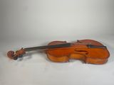 an old violin sitting on top of a white surface