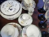 a table with a lot of dishes and cups on it