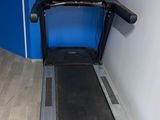 a treadmill in the corner of a room with a blue wall