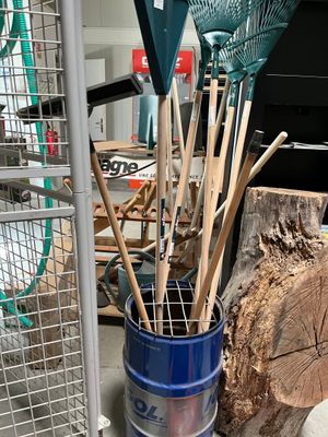 a blue bucket with a bunch of gardening tools inside of it