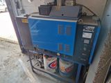 a blue machine that is sitting in a garage