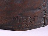 a close up of a metal object on a white surface