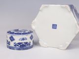 a small blue and white box and a small blue and white container