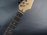 a close up of an electric guitar on a black background