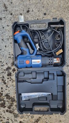 a tool in the case on the ground with a cord