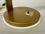 an image of a gold and white lamp on a table