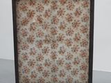 a close up of a fireplace screen with flowers on it
