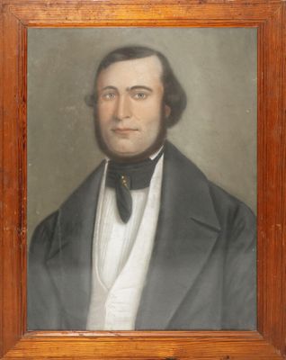 portrait of a man in a suit and bow tie in a wooden frame