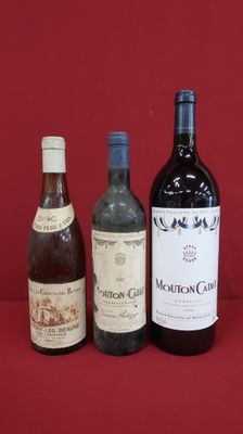 three bottles of wine are lined up on a red surface