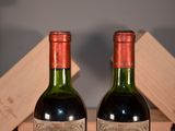 two bottles of wine sitting next to each other on a table