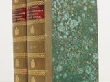two books sitting on top of each other on a white surface