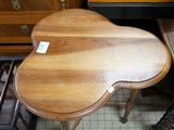 a small wooden table with a heart shaped top on it