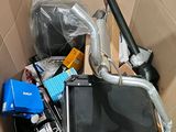 a cardboard box filled with assorted electronics and other items